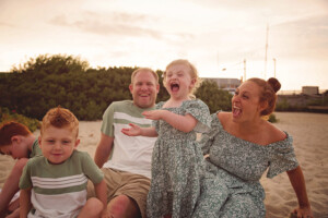 small child laughing on the beach