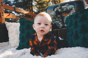 a baby boy in the back of a holiday pickup truck parked along the Yardley Canal