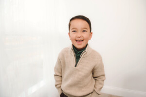 a kid smiling for studio holiday portraits in bucks county