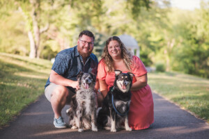 family posed for portraits in Core Creek Park with dogs.