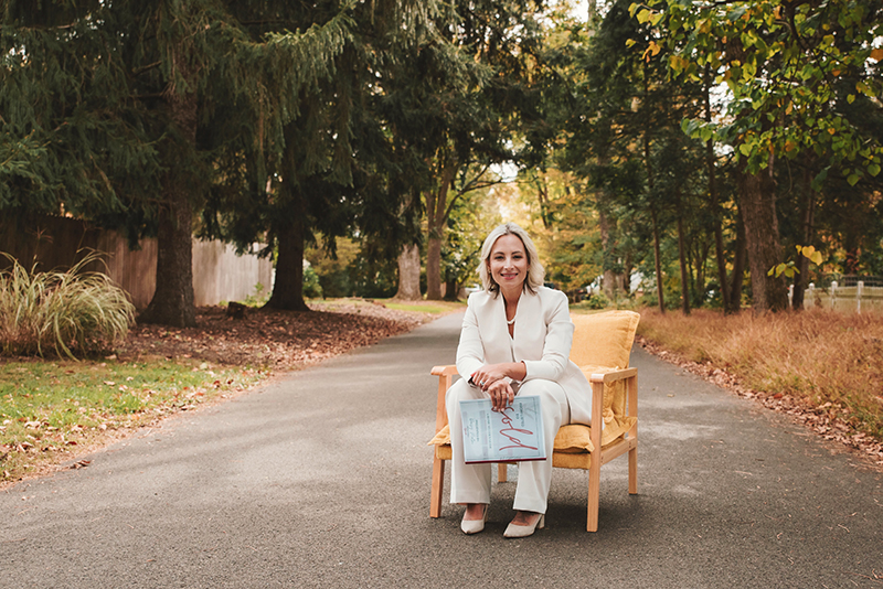 019_Fall2025smaill real estate agent sitting in road with sold sign