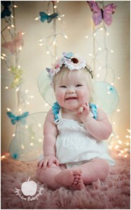 Child with Down syndrome smiling during portrait session in Bucks County PA