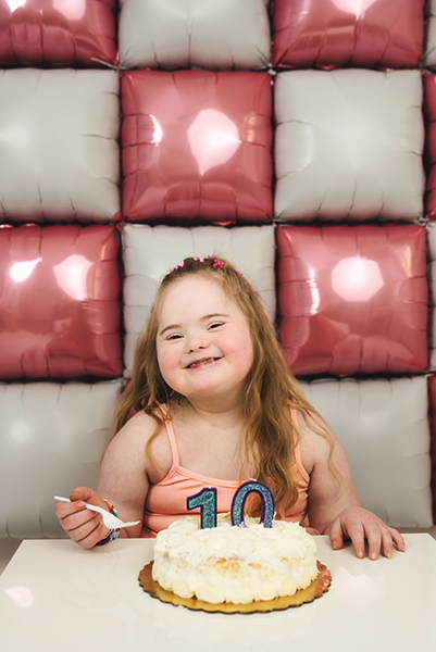 Joyful candid portrait of child with Down syndrome laughing Bucks County photographer