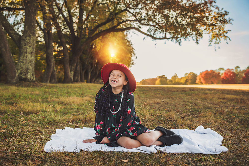 Girl in a golden field at sunset in Bucks County — playful fall photography by Appletini Photography
