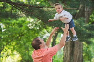 little boy being tossed in the air by Dad at Core Creek Park
