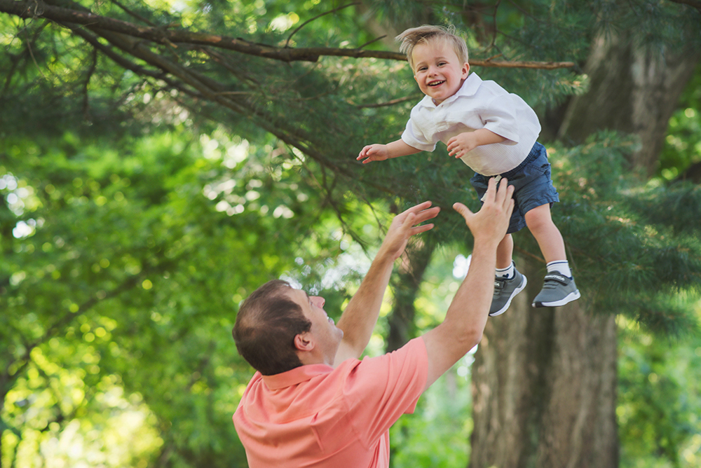 little boy being tossed in the air by Dad at Core Creek Park