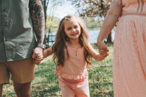 Family walking together on a trail at Core Creek Park during spring portraits