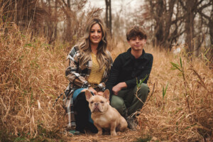 The family posed for fall portraits with the dog for a session with Appletini Photography.