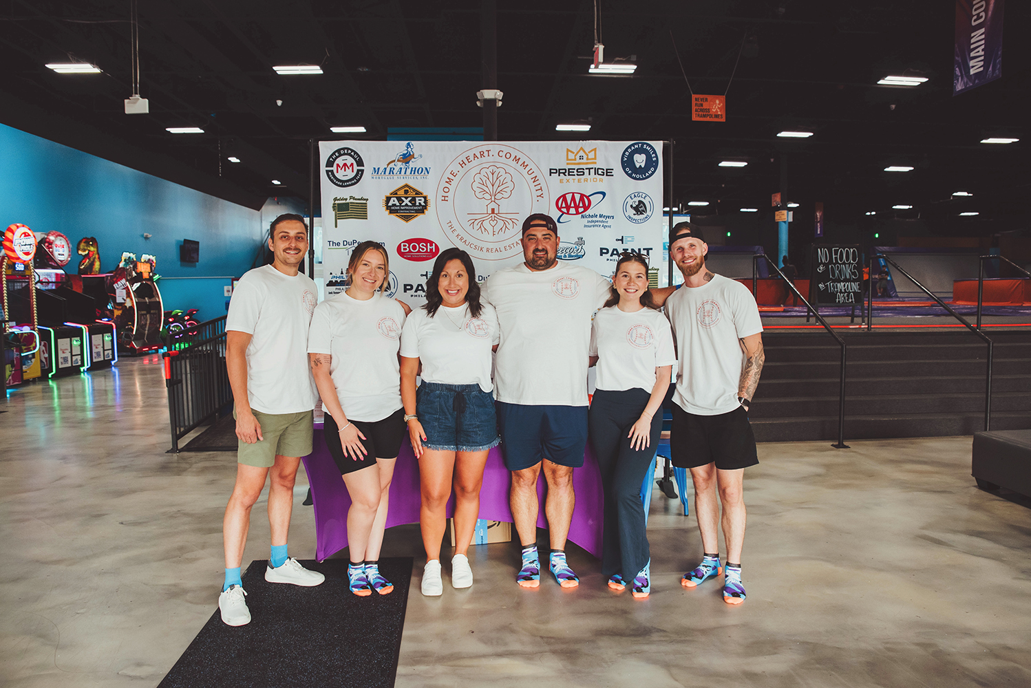 Real estate agents hosting a community appreciation event at a local trampoline park.