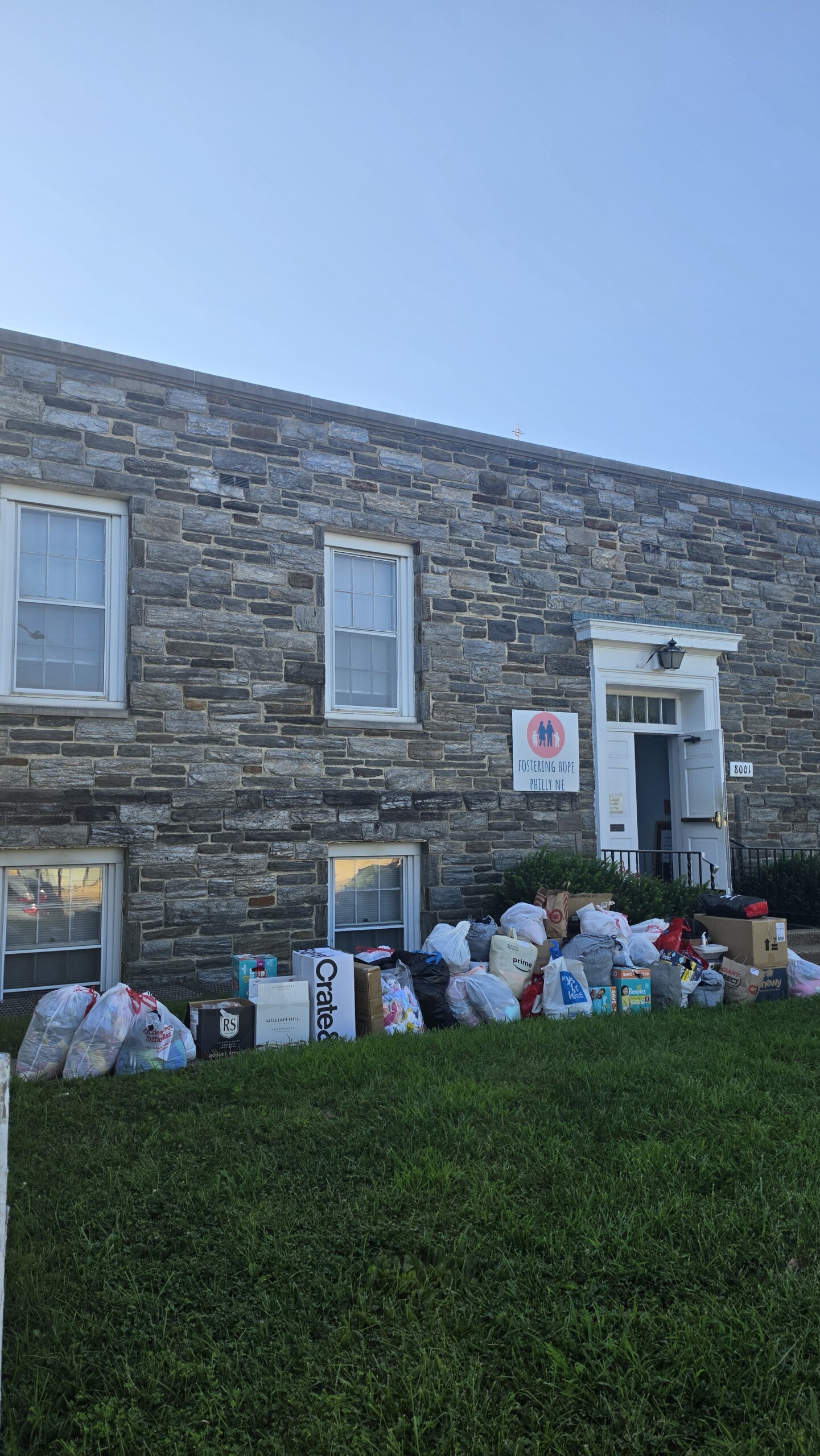Bags of donated children’s clothing outside the Fostering Hope Philly-NE location after a community clothing drive.